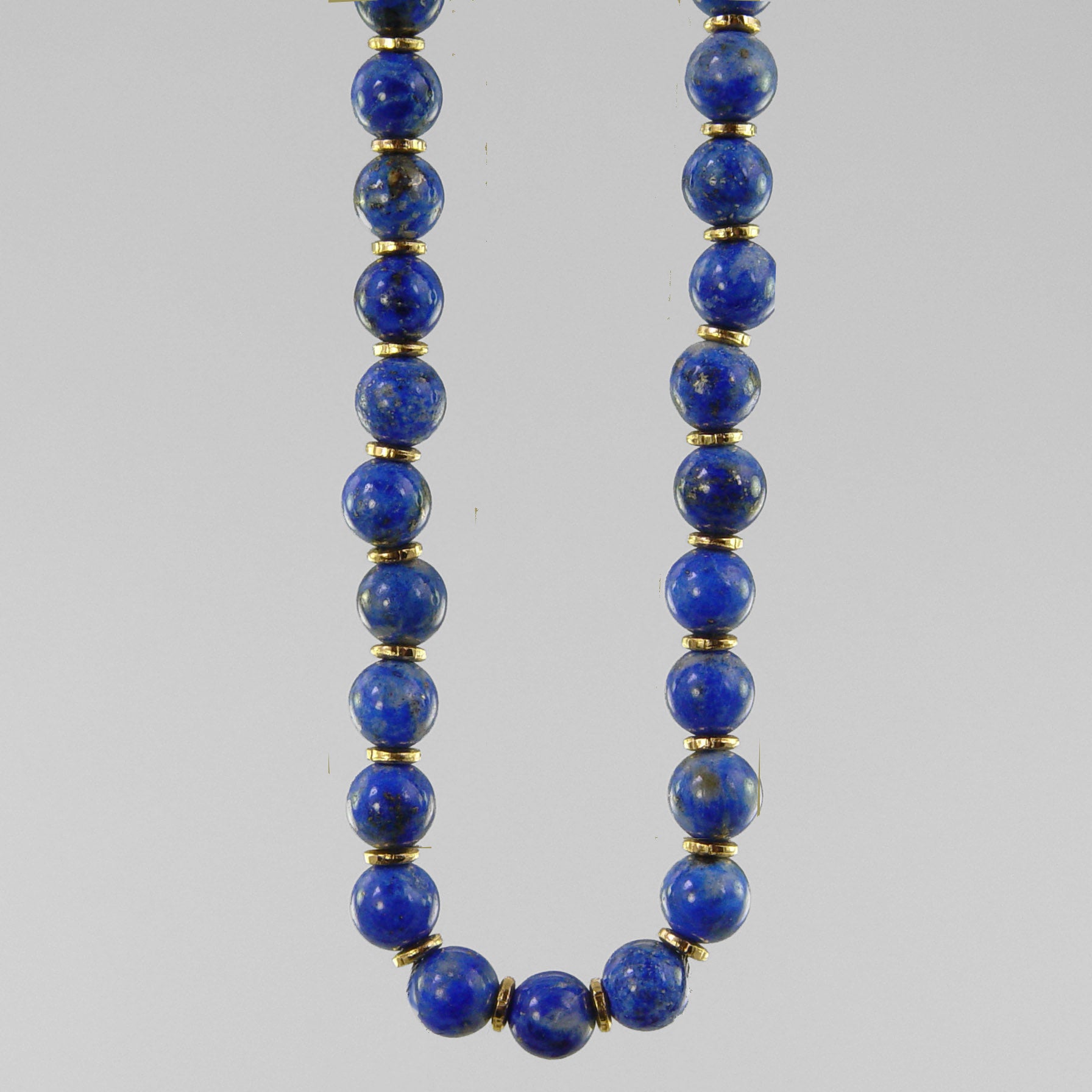 Lot - A lapis lazuli and gold bead necklace